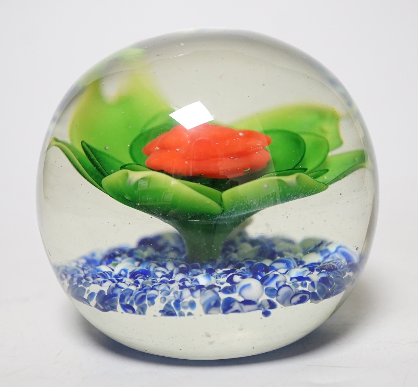 A large floral glass paperweight, 9cm tall